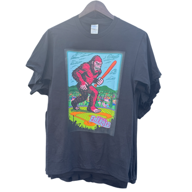 Blue t-shirt with a colorful graphic of a Sasquatch holding a baseball bat.