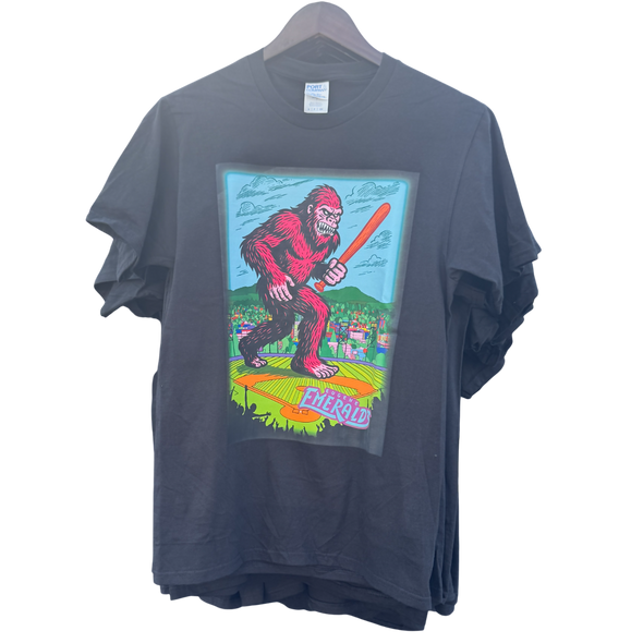 Blue t-shirt with a colorful graphic of a Sasquatch holding a baseball bat.