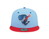 A fitted, baby blue and red cap with an embroidered Exploding Whales mark on the front.